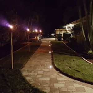 Side paver walkway lit up at night