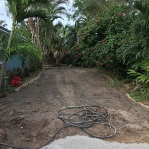 Removal of old grass, prepping for paver walkway, flower bed and new sod